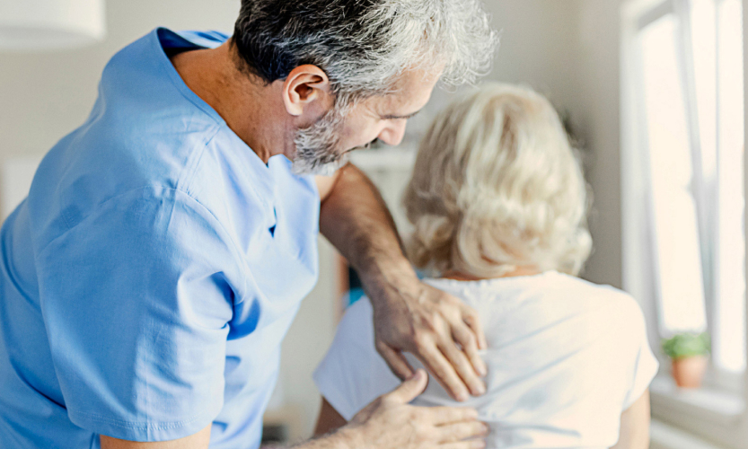 Male Chiropractor Adjusting a Woman's Back