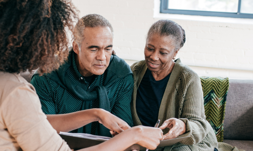An elderly couple looking going over estate paperwork together
