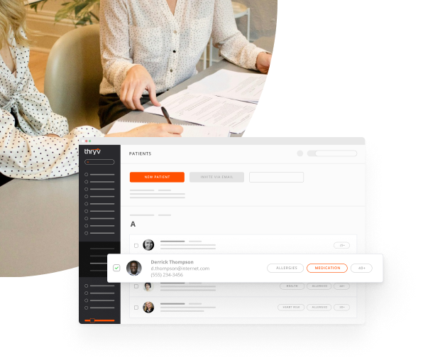 Personal Injury Lawyer Signing Documents with Her Client with a Snapshot of Thryv's CRM for Lawyers