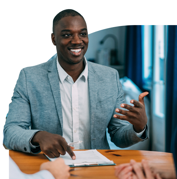 A business man with a clipboard having a conversation in a meeting.