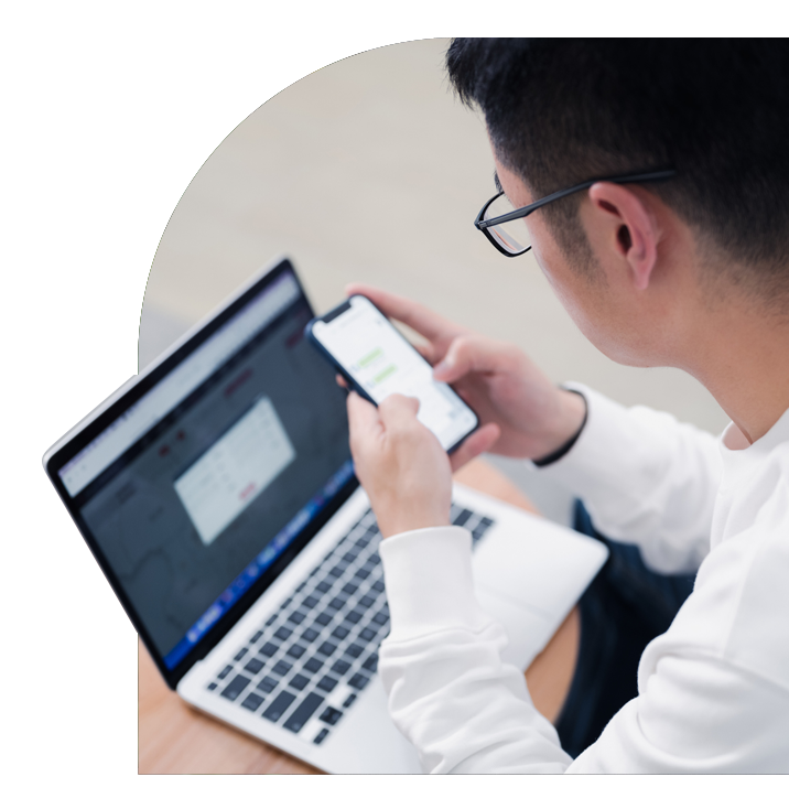 Male Business Owner With a White Long-Sleeved Shirt and Black Glasses Using Thryv's WebChat Tool.