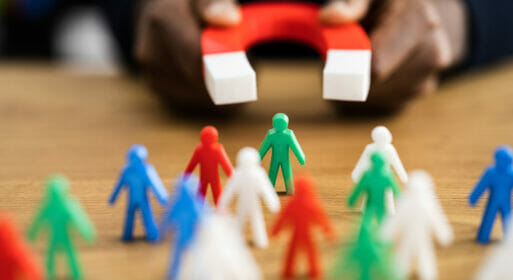 A magnet pointed towards a group of toy figures