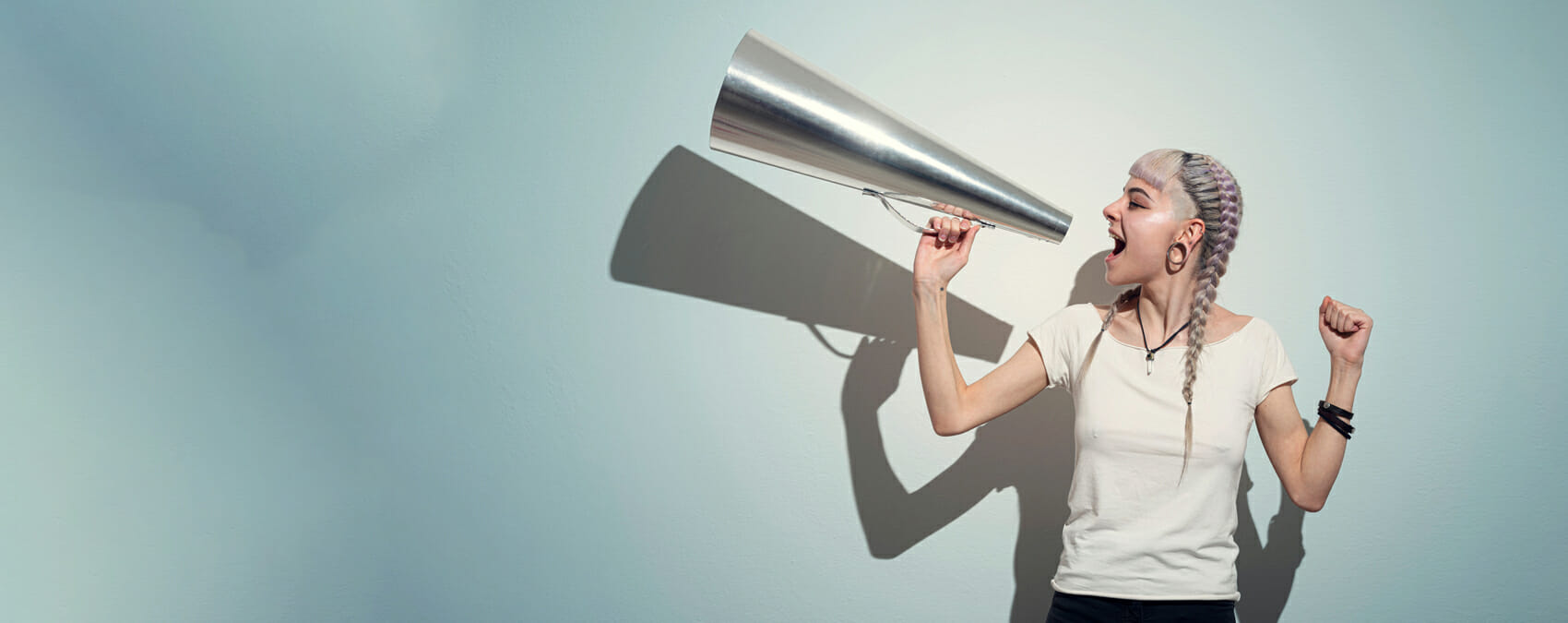 Young woman yelling into a megaphone